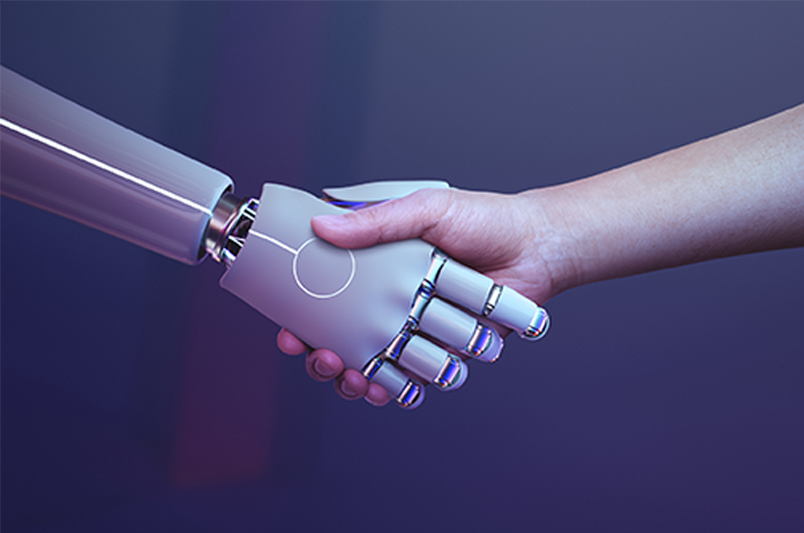 Mano humana estrechando la mano de un robot para expresar la colaboración entre la inteligencia artificial al servicio del ser humano.